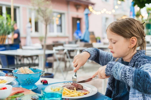 Маленькая девочка ужинает на террасе в ресторане — стоковое фото