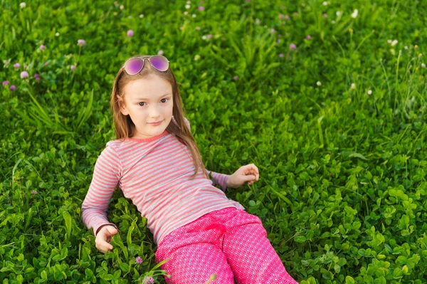 Vertical portrait of a cute little girl of 7 years old in the park — Stock Photo, Image