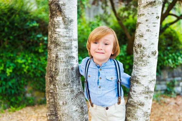 Close up portrait of adorable little blond boy, wearing pants with suspenders — Stock Photo, Image