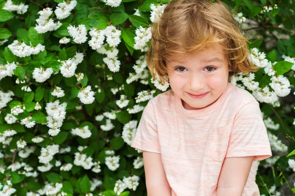 Outdoor close up portrait of adorable little blond boy of 4 years old with hairstyle and sweet smile on his face — Stock Photo, Image