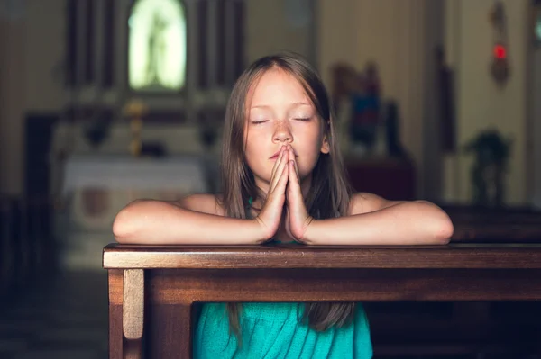 Child praying in church