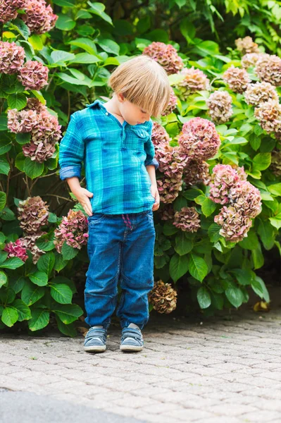 Outdoor portrait of a cute little boy of 4 years old, wearing emerald shirt and denim jeans — Stock Photo, Image