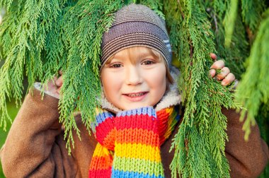 Açık parkta oynarken güzel soğuk bir günde şirin küçük bir çocuk portresi