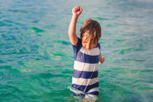 Adorable kid having fun on summer vacation, playing in the sea, image taken in Tropea, Calabria, Italy — Stock Photo, Image