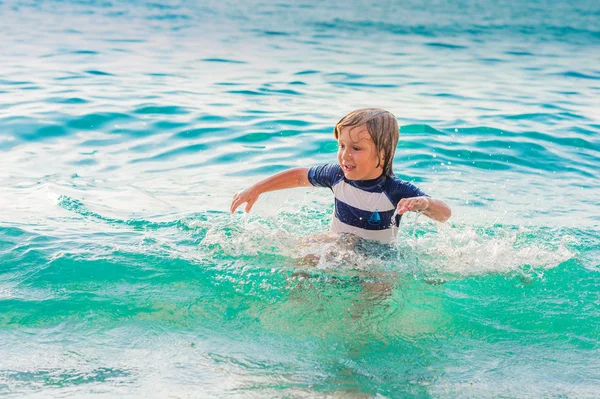 Adorable kid having fun on summer vacation, playing in the sea, image taken in Tropea, Calabria, Italy — Stock Photo, Image