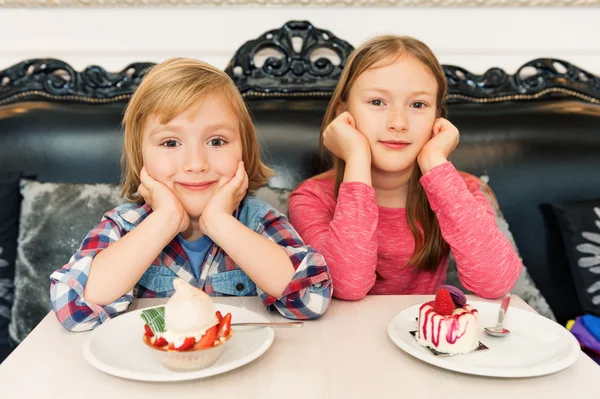 Adorable dzieci jedzenia ciasta w kawiarni — Zdjęcie stockowe