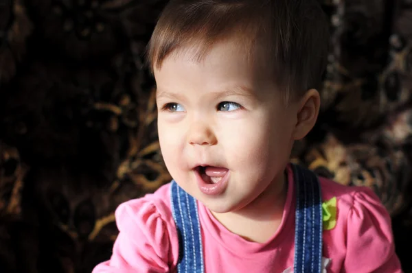 Funny little girl in dark background — Stock Photo, Image