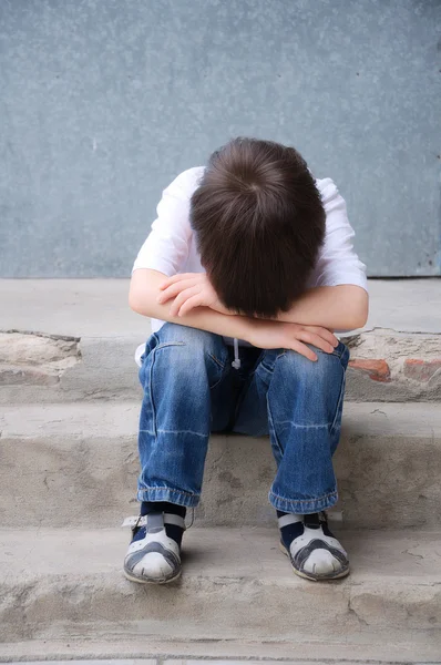 Boy upset siiting head on the hands — Stock Photo, Image