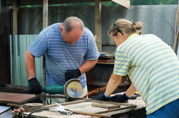 Workers cutting metal with angle grinder — Stock Photo, Image