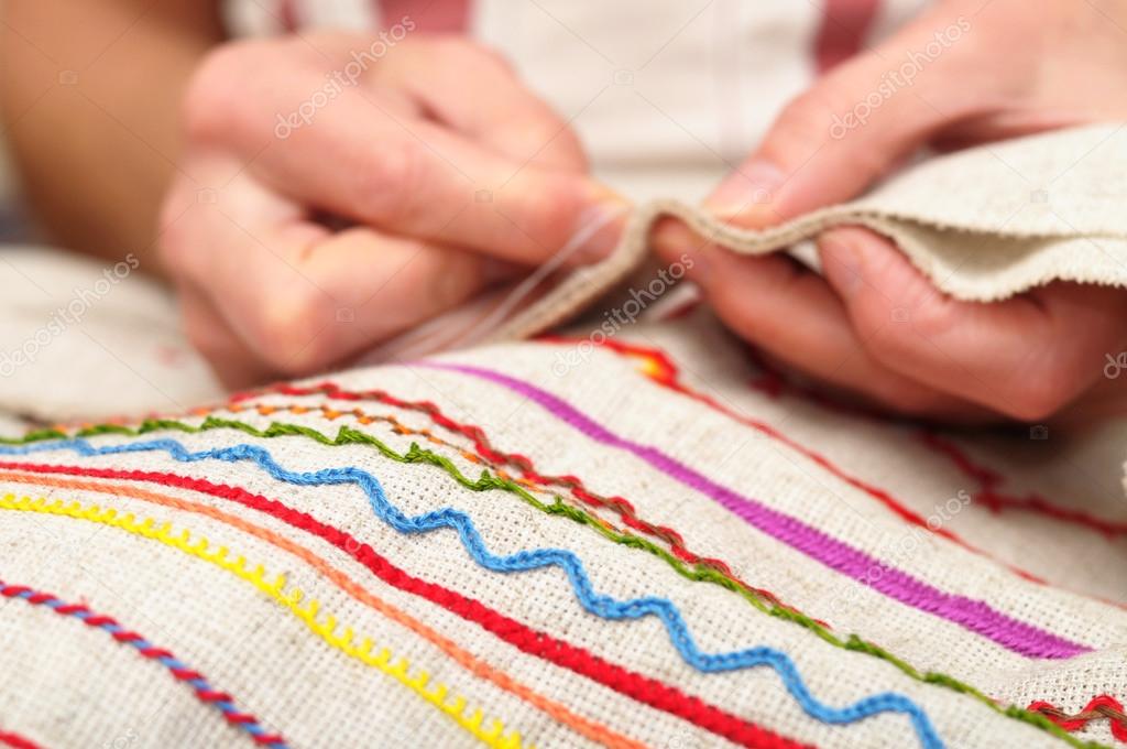patterns on fabric and hands sewing