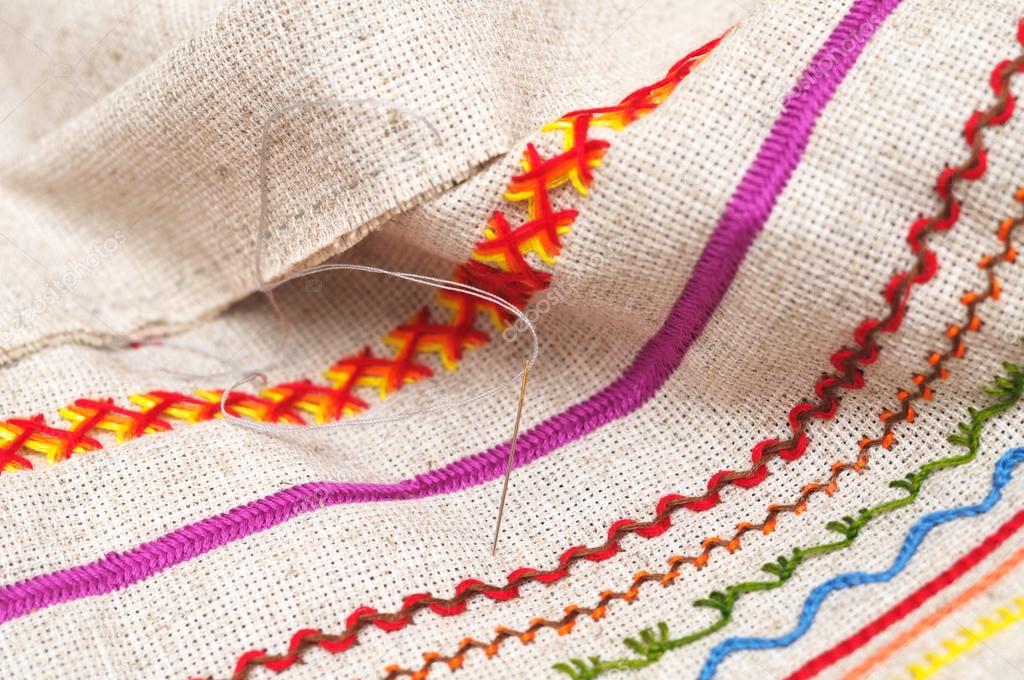 needle on fabric with embroidery