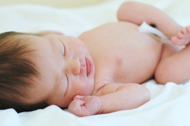 Newborn baby with umbilical cord sleeping clipart