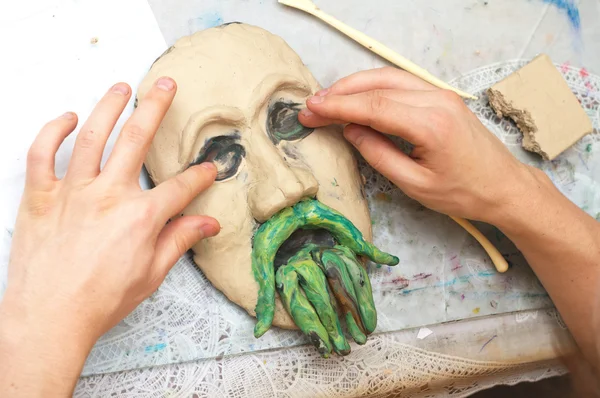 Hands sculpting plasticine form of face — Stock Photo, Image