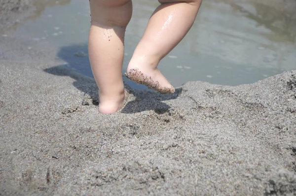 Baby feet dancing on the sand