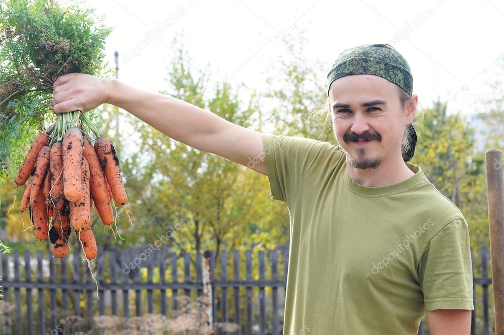 Happy farmer with carrots