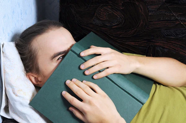 Man peeping from behind the book — Stock Photo, Image