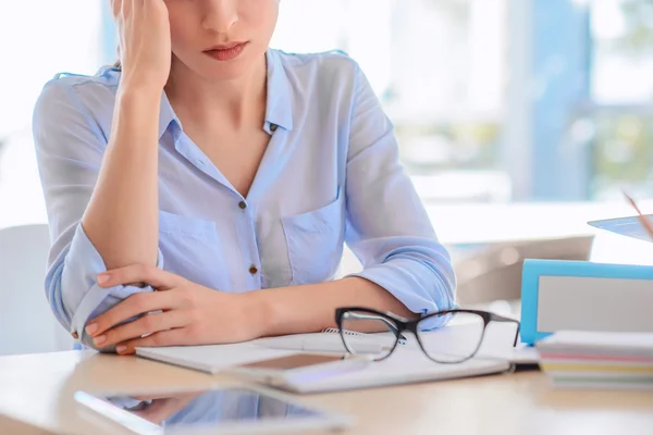 Sad woman sitting at the table Stock Photo