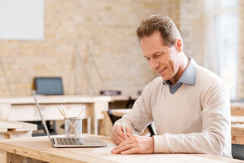 Positive man sitting at the table