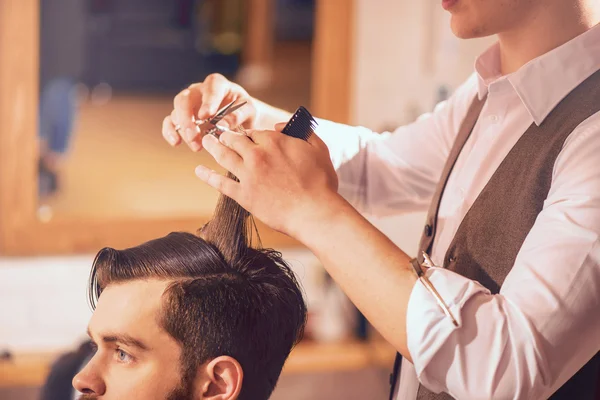 Professional barber cutting hair of his client — Stock Photo, Image