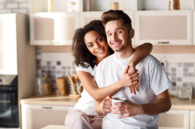 Positive couple resting in the kitchen