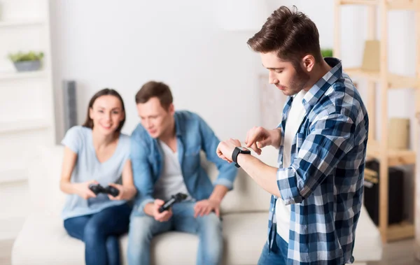 Pleasant guy looking at his wrist watch — Stock Photo, Image