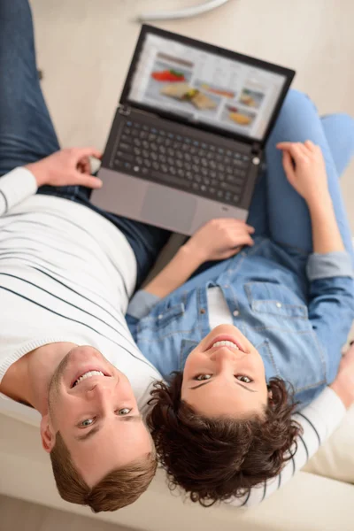 Casal positivo sentado no sofá — Fotografia de Stock