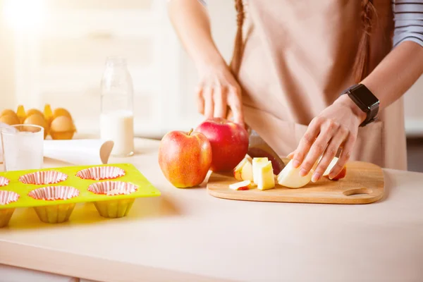 Pleasant woman chopping apple — Stock Photo, Image