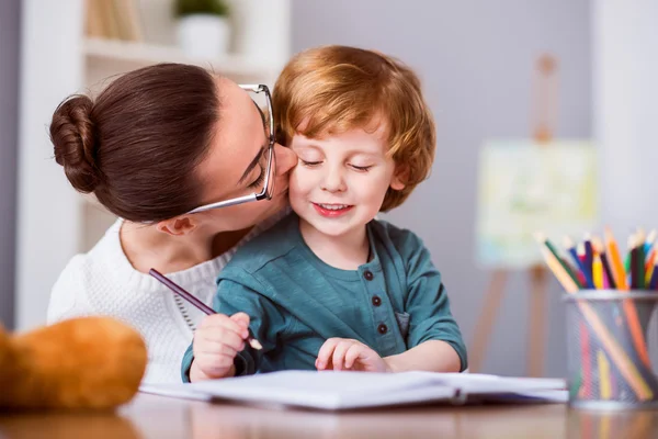 Pretty woman kissing her son — Stock Photo, Image