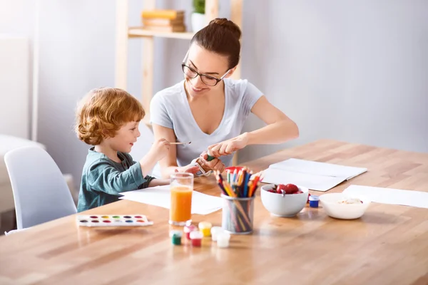 Woman painting with her son