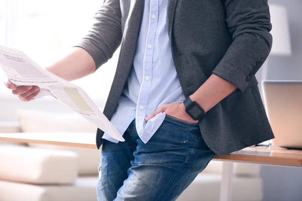 Mano del hombre sosteniendo un periódico — Foto de Stock