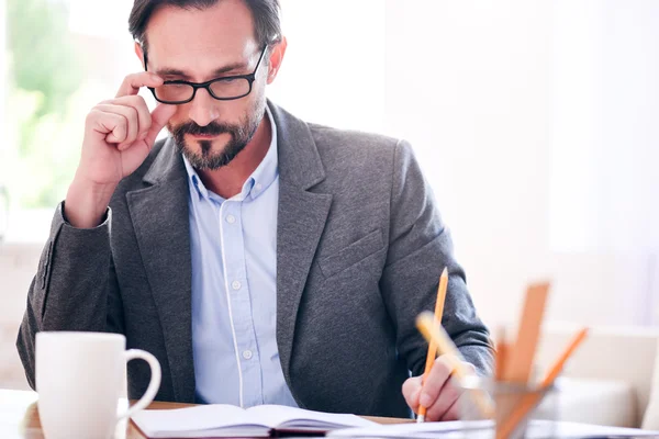 Man thinking and touching glasses — Stock Photo, Image