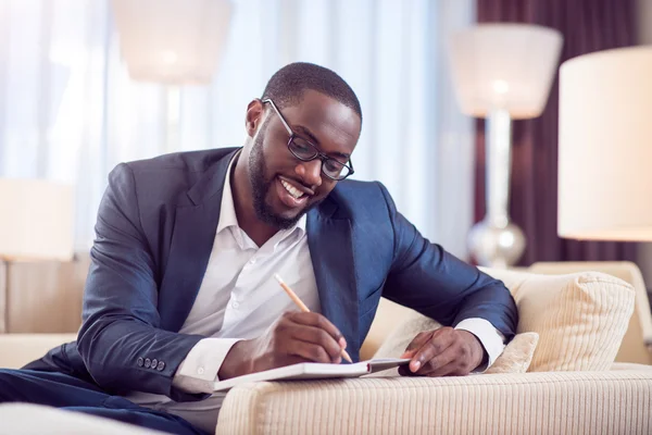 Afro American man taking notes