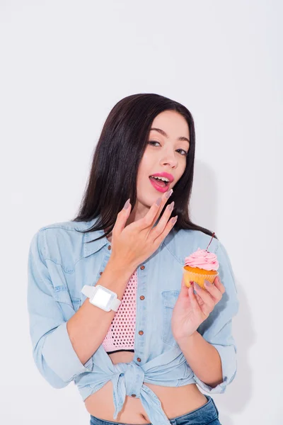 Joyful woman eating cupcake — Stock Photo, Image