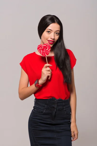 Pleasant charming woman holding lollypop — Stock Photo, Image