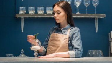Cheerful delighted woman standing at the counter