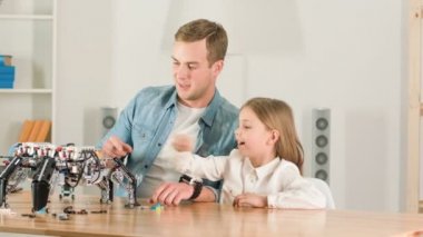 Olumlu baba ve kızı masada oturan