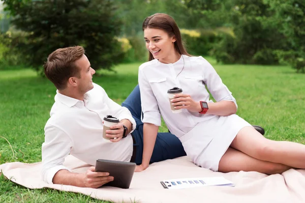 Positive colleagues resting on the grass, — Stock Photo, Image