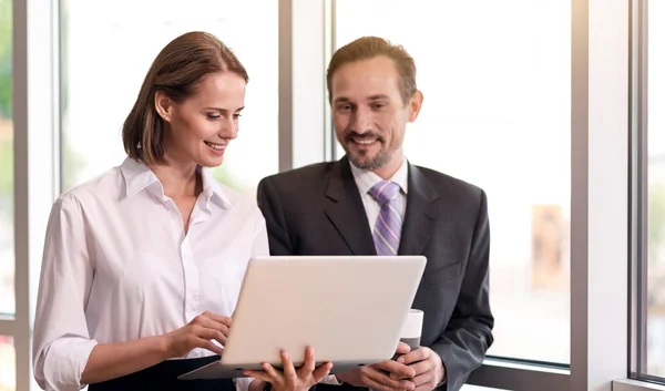 Positive colleagues using laptop — Stock Photo, Image