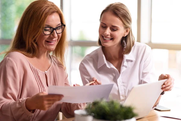 Belgelerle çalışan neşeli iş arkadaşları