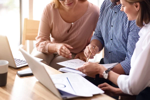 Pleasant colleagues sitting at the table — Stock Photo, Image