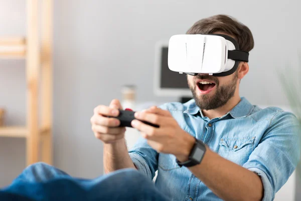 Delighted man playing video games