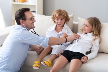 Man playing with his children clipart