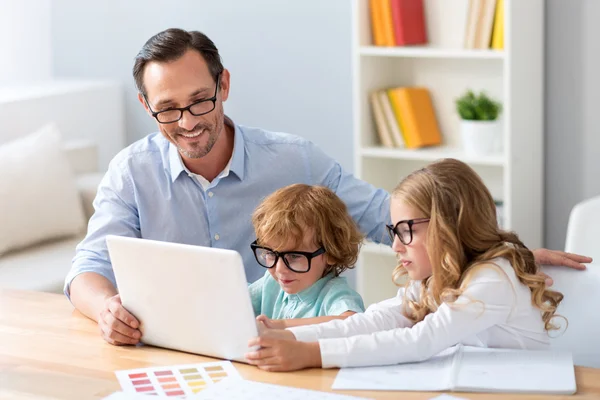 Hombre sentado a la mesa con niños —  Fotos de Stock