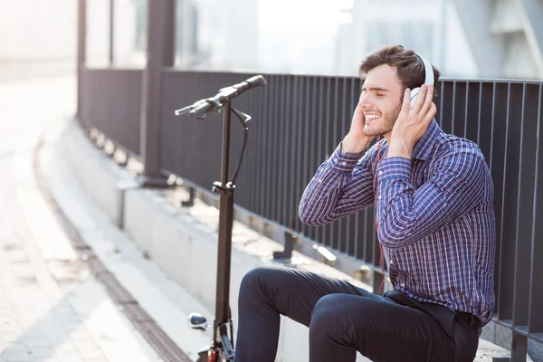 Счастливый улыбающийся мужчина слушает музыку — стоковое фото