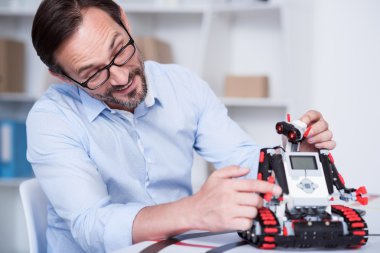Yaşlı adam eğlenceli sahip bir robot ile oynamak