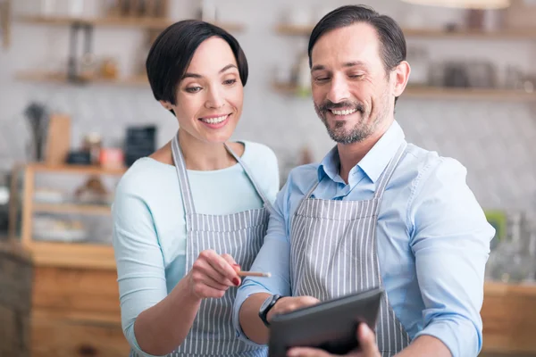 Two business owners in aprons standing in cafe — Stock Photo, Image