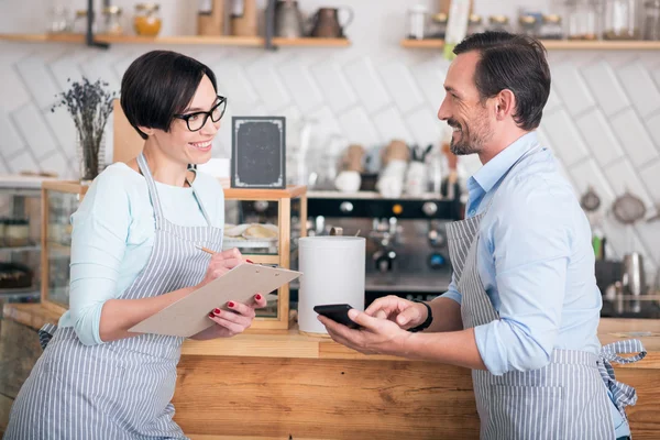 Two business owners in aprons working in cafe — Stock Photo, Image