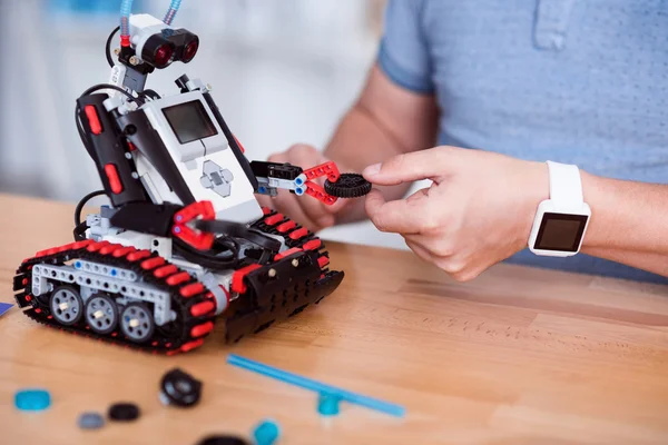 Pleasant man constructing robot. — Stock Photo, Image