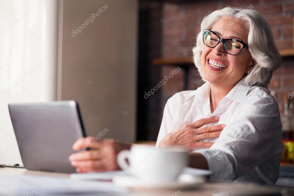 Caucasian woman being happy using computer for family communication