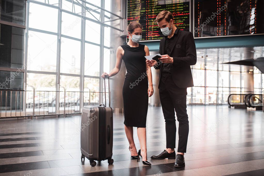 Man and woman checking their boarding passes